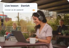 An employee joining a live Danish lesson on her laptop outdoors, prompted with “Hvordan var din weekend?”
